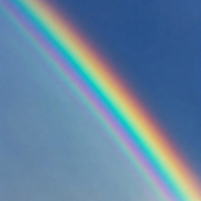 Vibrant Rainbow in Blue Sky