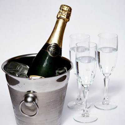 Champagne Bottle in Ice Bucket with Glasses