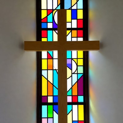 Wooden Cross in Front of Stained Glass Window