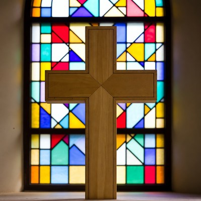 Wooden Cross Before Stained Glass Window