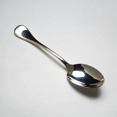 Shiny silver spoon on white background