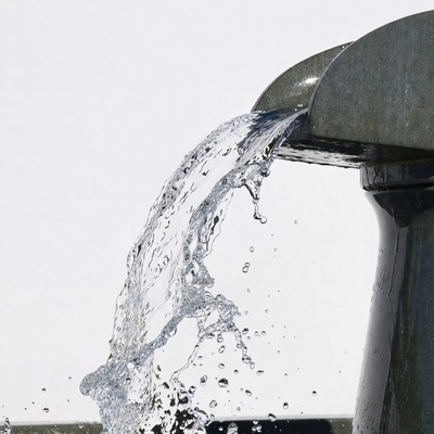 Water Pouring from Metal Spout