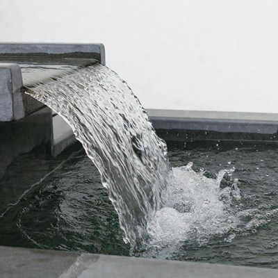 Water pouring from stone fountain