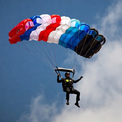 Man skydiving with colorful parachute