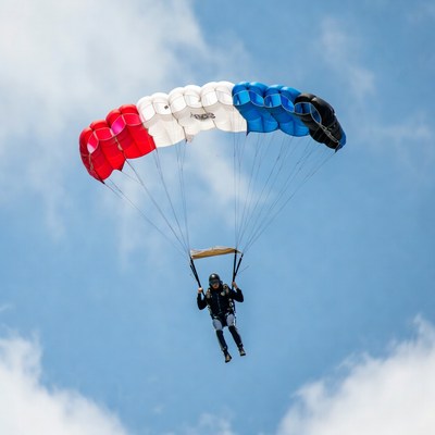 Man parachuting with French flag parachute