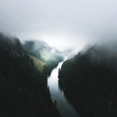 River winding through foggy mountains
