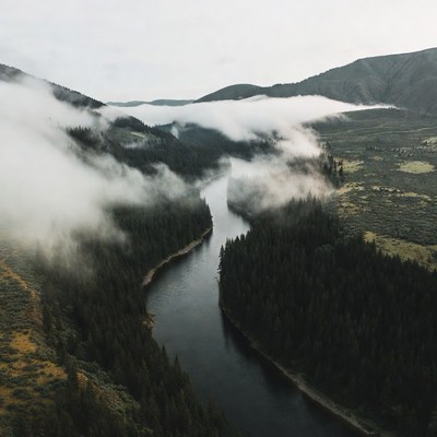 River Winding Through Misty Mountains