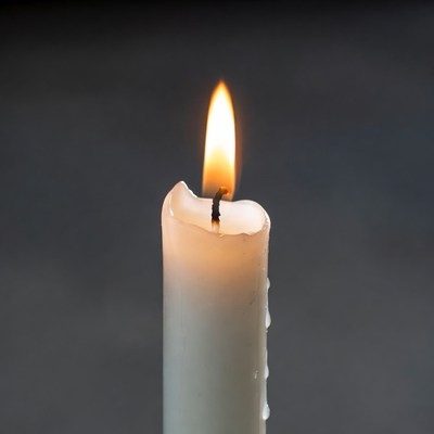 Burning Candle Flame on Dark Background