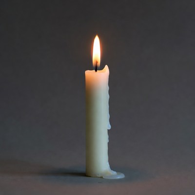 Burning white candle with dripping wax