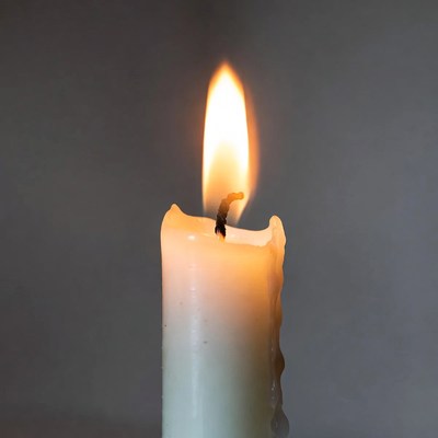 Burning white candle flame