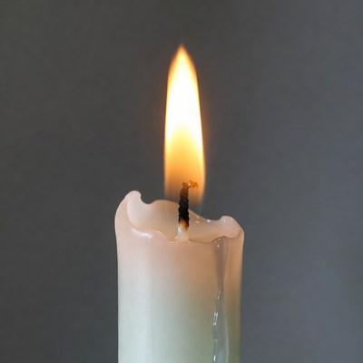 Burning white candle flame