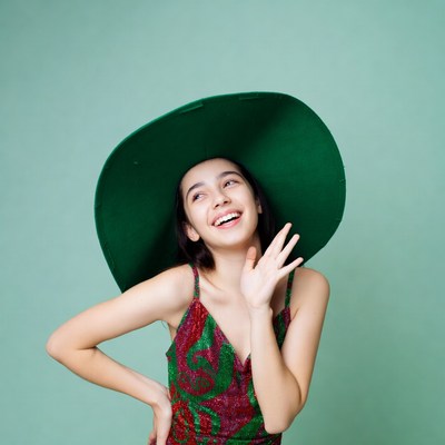 Asian girl smiling in green wide-brim hat