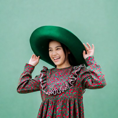 Asian girl smiling in green hat