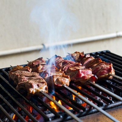 Skewered meat grilling on barbecue