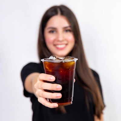 Woman holding iced coffee cup