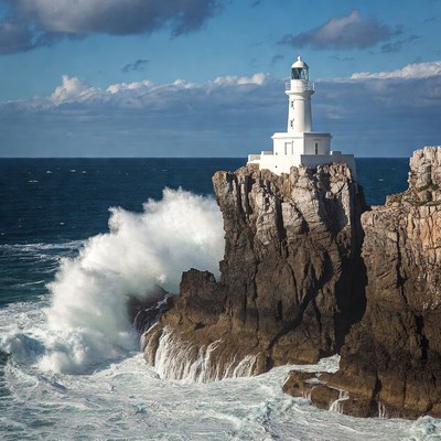 White Lighthouse on Cliff with Crashing Waves