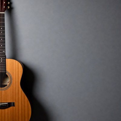 Acoustic Guitar Against Gray Wall