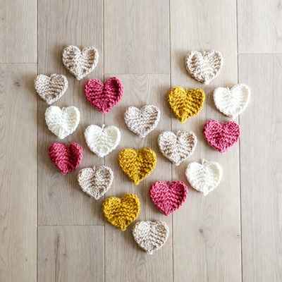 Colorful Crochet Hearts on Wooden Floor