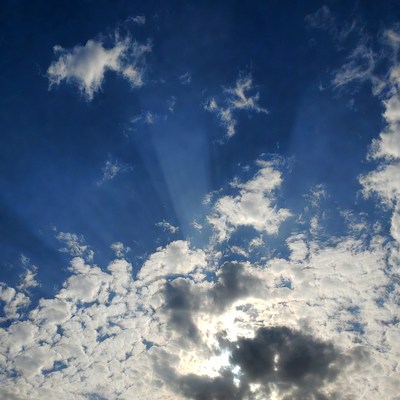 Sun rays through fluffy clouds