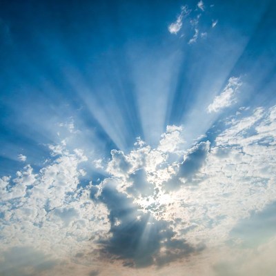 Sun rays beaming through clouds