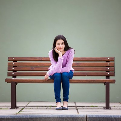 Young woman sitting on bench