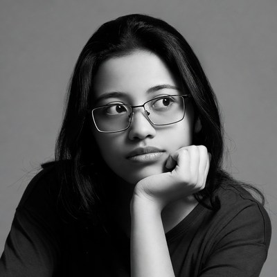 Asian woman with glasses thoughtful pose