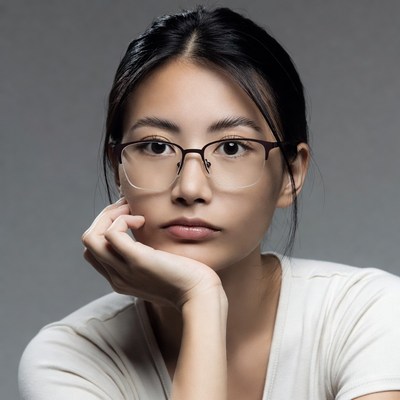 Asian woman with glasses hand on chin
