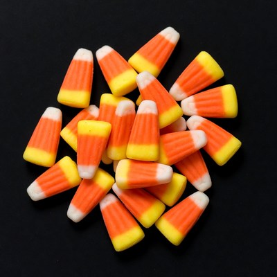 Candy corn pile on black background