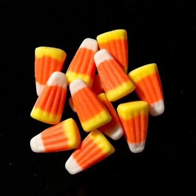 Candy corn pile on black background