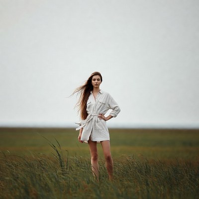Woman in white dress in tall grass