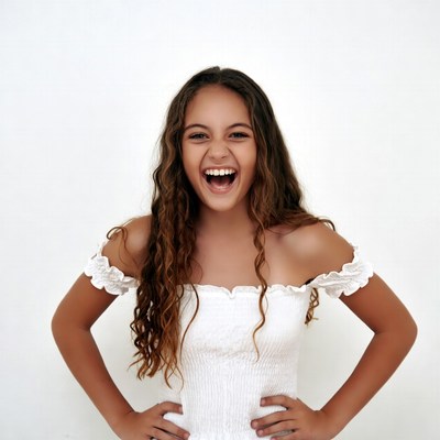 Teen girl laughing with hands on hips