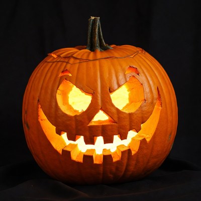 Lit Jack-o-Lantern Pumpkin on Black Background