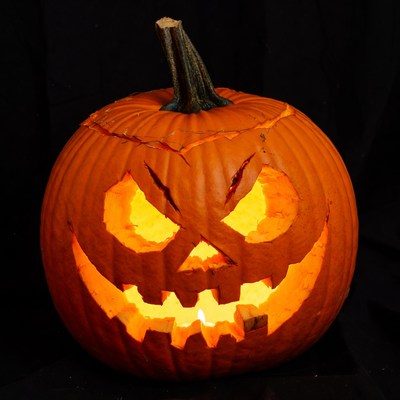 Lit Jack-o-Lantern Pumpkin on Black Background