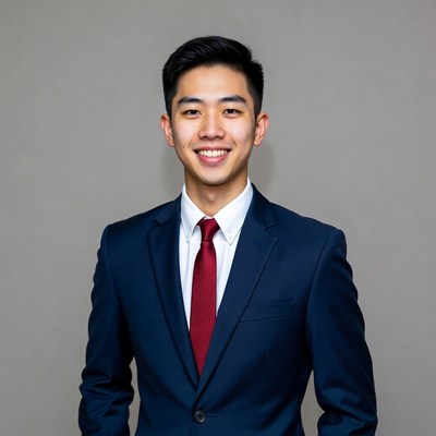 Asian man in navy suit smiling