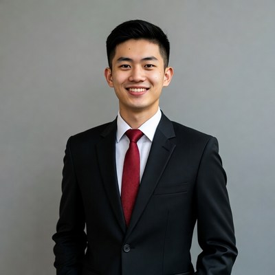 Asian man in black suit smiling