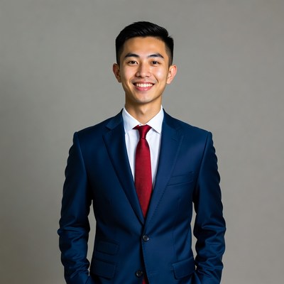 Asian man in navy suit smiling