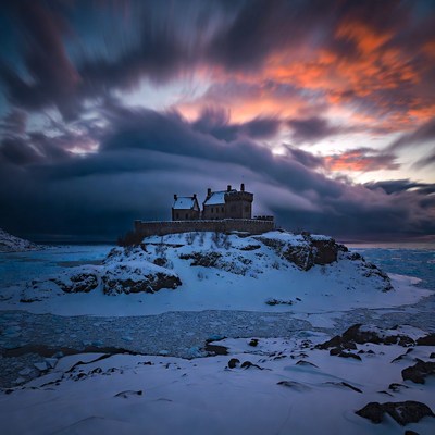 Castle on Snowy Rocky Island at Sunset