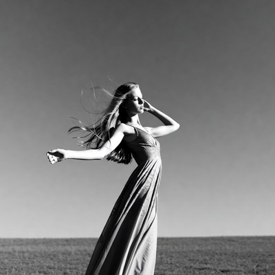 Woman in flowing dress dancing in field