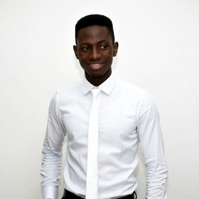 African-American man in white suit smiling