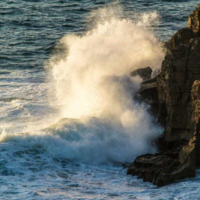 Ocean Wave Crashing Against Rocks