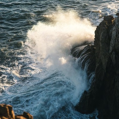 Ocean Waves Crashing Against Cliff