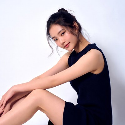 Asian woman sitting in black dress