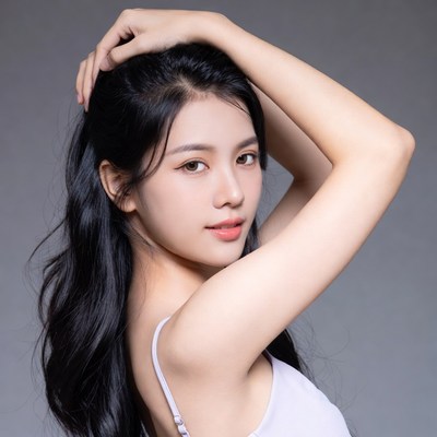 Asian woman posing with hand in hair