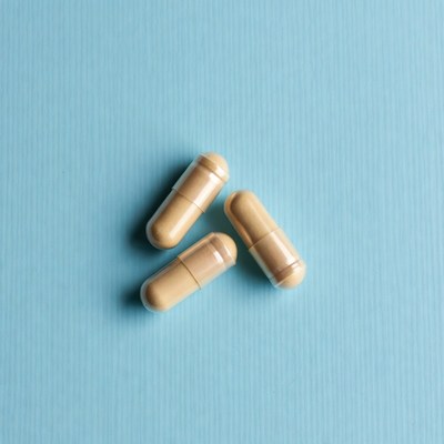 Three beige capsules on blue background
