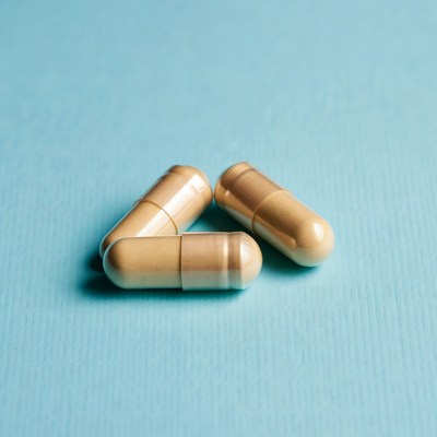 Beige capsules on blue background