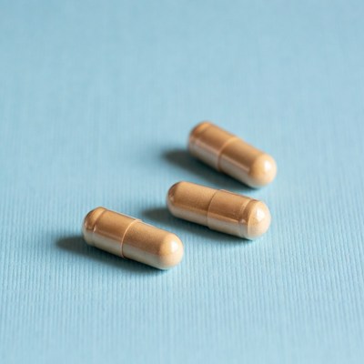 Three beige capsules on blue background