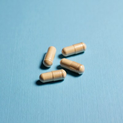 Four beige capsules on blue background