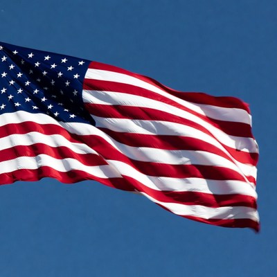 American flag waving against blue sky
