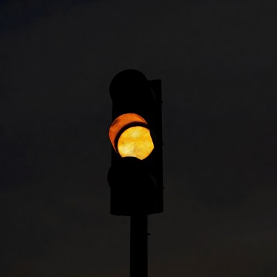 Yellow traffic light at night