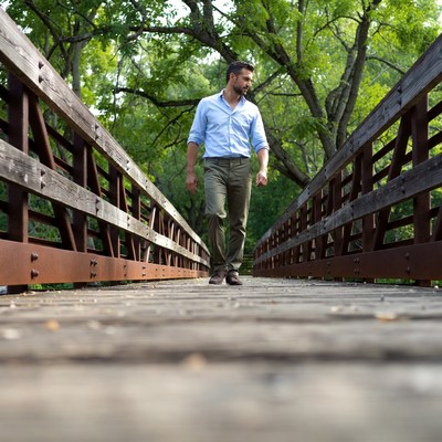 Man walking on wooden bridge